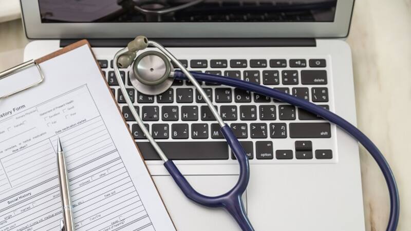 Stethoscope and prescription on laptop