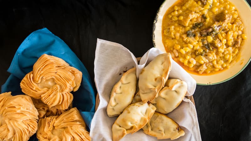 dishes of locro empanadas and sweet pastries, traditional Argentine foods that are frequently consumed for national holidays, such as the revolution of May 25 and independence on July 9