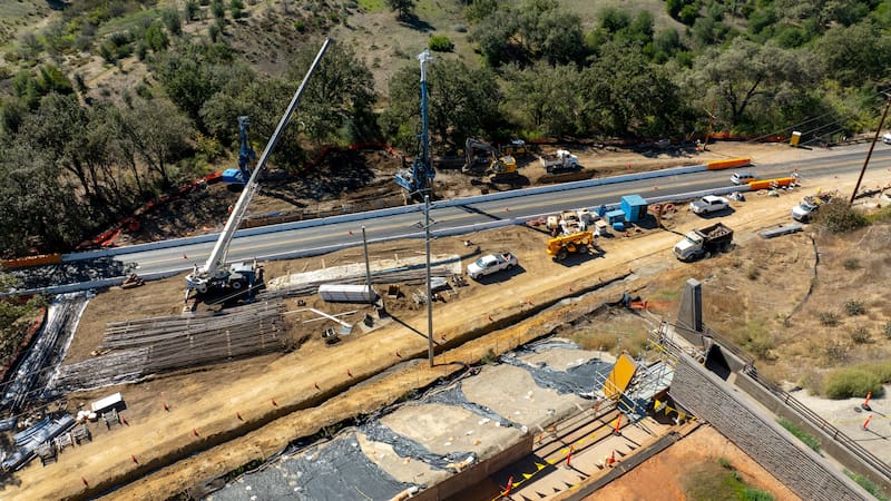 Agoura Hills, CA 2025 Oct 29 Aerial Wallis Annenberg Wildlife Crossing at Liberty Canyon, bridge crossing under construction over the 101 freeway, highway. Santa Monica mountains new native vegetation. Agoura Road