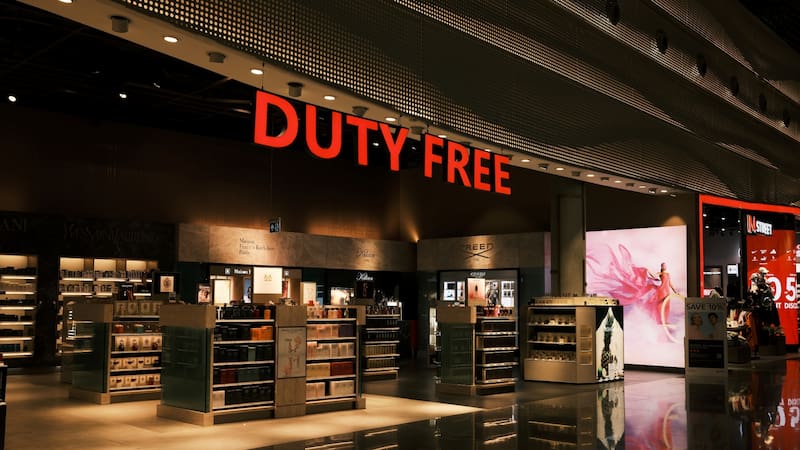 A vibrant duty-free shop with illuminated shelves displaying perfumes and luxury goods. The bold red DUTY FREE sign stands out, enhancing the upscale atmosphere. Istanbul, Turkey - 1.03.2025