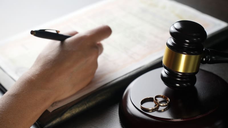 Una persona firma el divorcio.