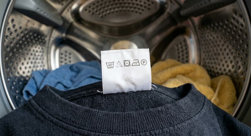 El triángulo tachado en las etiquetas textiles advierte que no se deben utilizar blanqueadores, ya que pueden dañar las fibras o alterar los acabados de la prenda.
