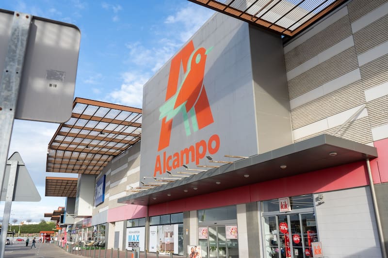 Entrada de un supermercado Alcampo en España con el cartel de la cadena visible en la fachada.