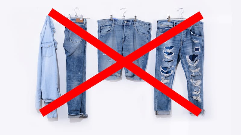 Hanging of blue torn jeans with back jeans with jeans shorts, with blue shirt on white background. Beauty and fashion