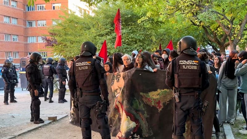 Agentes de la policía ante los estudiantes que estaban realizando un piquete informativo en frente de la Facultad de Ciencias Físicas en la Universidad Complutense de Madrid este miércoles.