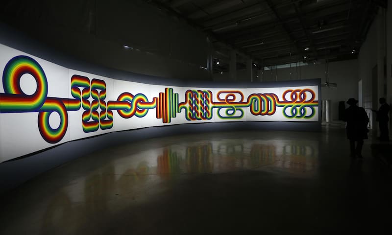Visitors pass by "La longue marche"(The long walk), a work of Argentinian artist Julio Le Parc, a pioneer of Op Art (Optical art), at the Palais de Tokyo museum in Paris on February 25, 2013. AFP PHOTO PIERRE VERDY
