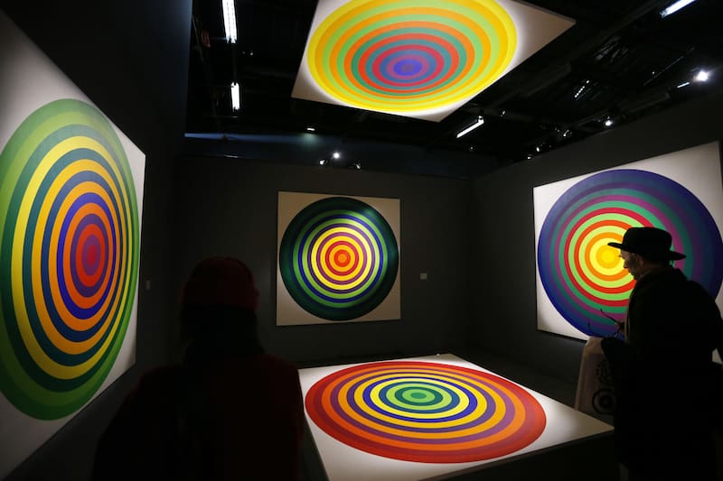 A visitor looks at "Serie 15, n°8", works of Argentinian artist Julio Le Parc, a pioneer of Op Art (Optical art), at the Palais de Tokyo museum in Paris on February 25, 2013. AFP PHOTO PIERRE VERDY