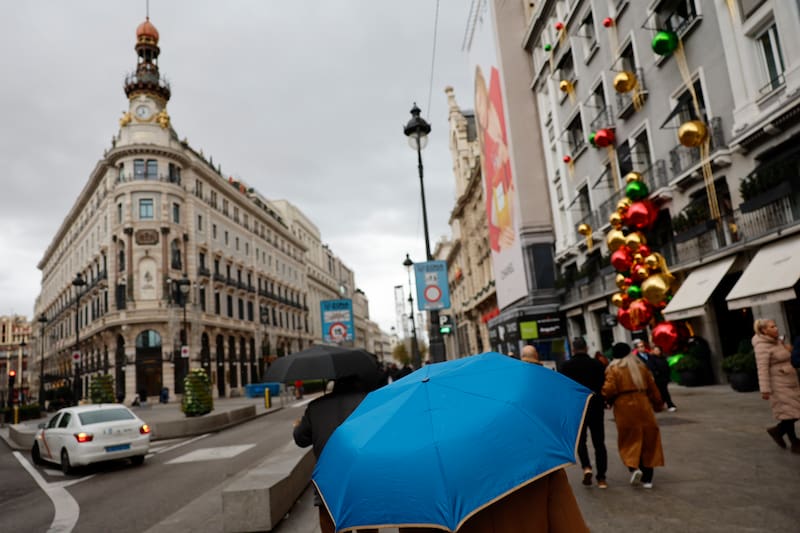 FOTODELDÍA MADRID, 04/12/2025.- Viandantes se protegen de la lluvia con paraguas por el centro de la capital. Lluvias débiles o localmente moderadas que se irán al final del día y una subida de las temperaturas mínimas, que no alcanzarán los 4º en la mayor parte de la región, así es la previsión meteorológica para este jueves según la Agencia Estatal de Meteorología (Aemet). Los cielos de la región de Madrid estarán nubosos y cubiertos y habrá brumas y nieblas matinales que serán más persistentes en zonas altas de la sierra. Las lluvias serán débiles o localmente moderadas, pero remitirán a lo largo de la tarde para desaparecer al final, salvo en la sierra donde, al final del día, serán débiles y dispersas. EFE/ Mariscal