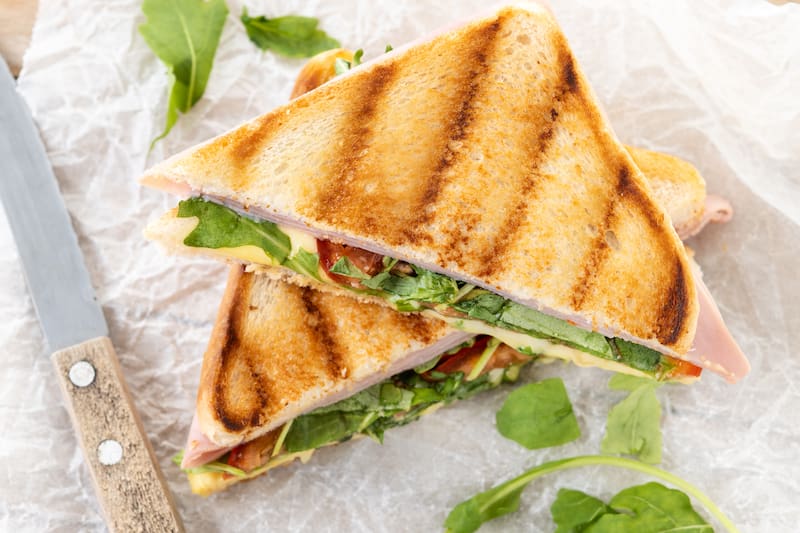 Rye bread adds earthy, nutty notes to grilled cheese, complementing melted cheese and creating a richer flavor.