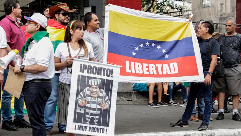 Sao Paulo, Brazil - February 17,2019: Unidentified group of people in a manifestation against the current government of Bolivia, with flags and cards.