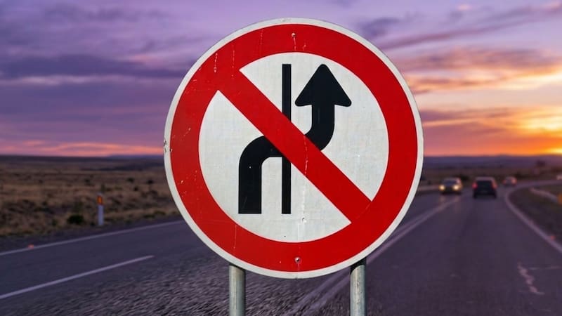 Pocos lo saben: qué significa la señal de tránsito con una flecha curva cruzada por una línea roja y sobre fondo blanco.
