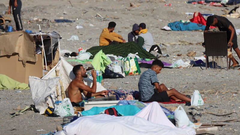 Migrantes acampando este sábado, en la playa El Trampolín de Ceuta (España).