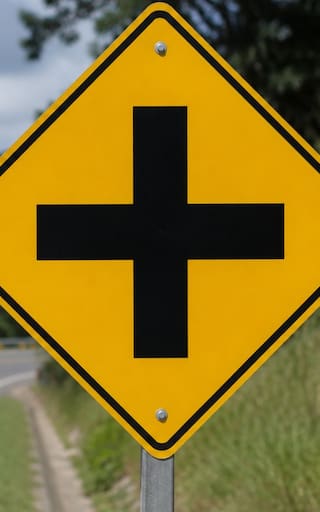 Ver una señal con una cruz negra sobre fondo amarillo: qué significa y para que se usa