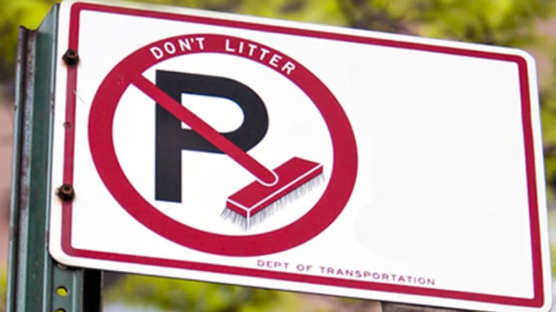 What the sign means with a black P crossed by a red broom inside a white and red circle.