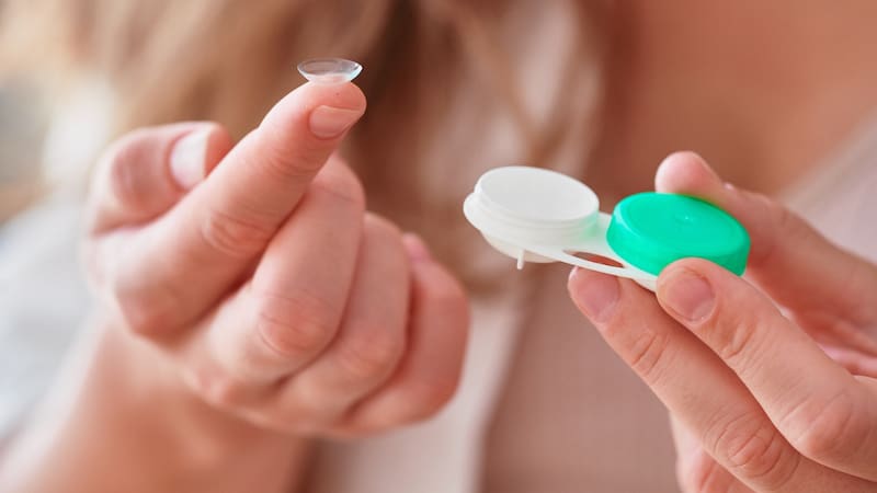 Young woman using soft contact lenses instead of glasses for vision correction